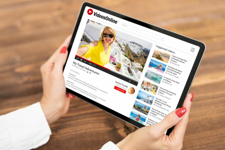 A woman is holding a tablet with a website on it