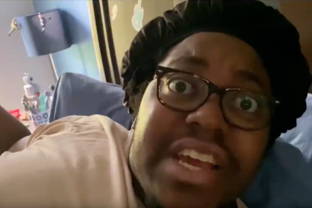Apple remote work ad scene of a person joining a morning video call from bed, highlighting the humor of work-from-home challenges.